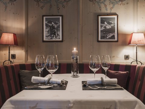 Pictures from Sportalm Cozy dining table with candle, two place settings, and lamps in wooden room